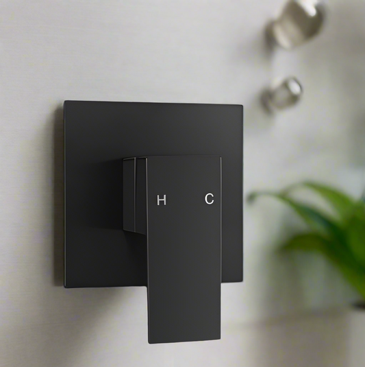 Wall-mounted square shower mixer tap with matte black finish, featuring hot and cold handles.