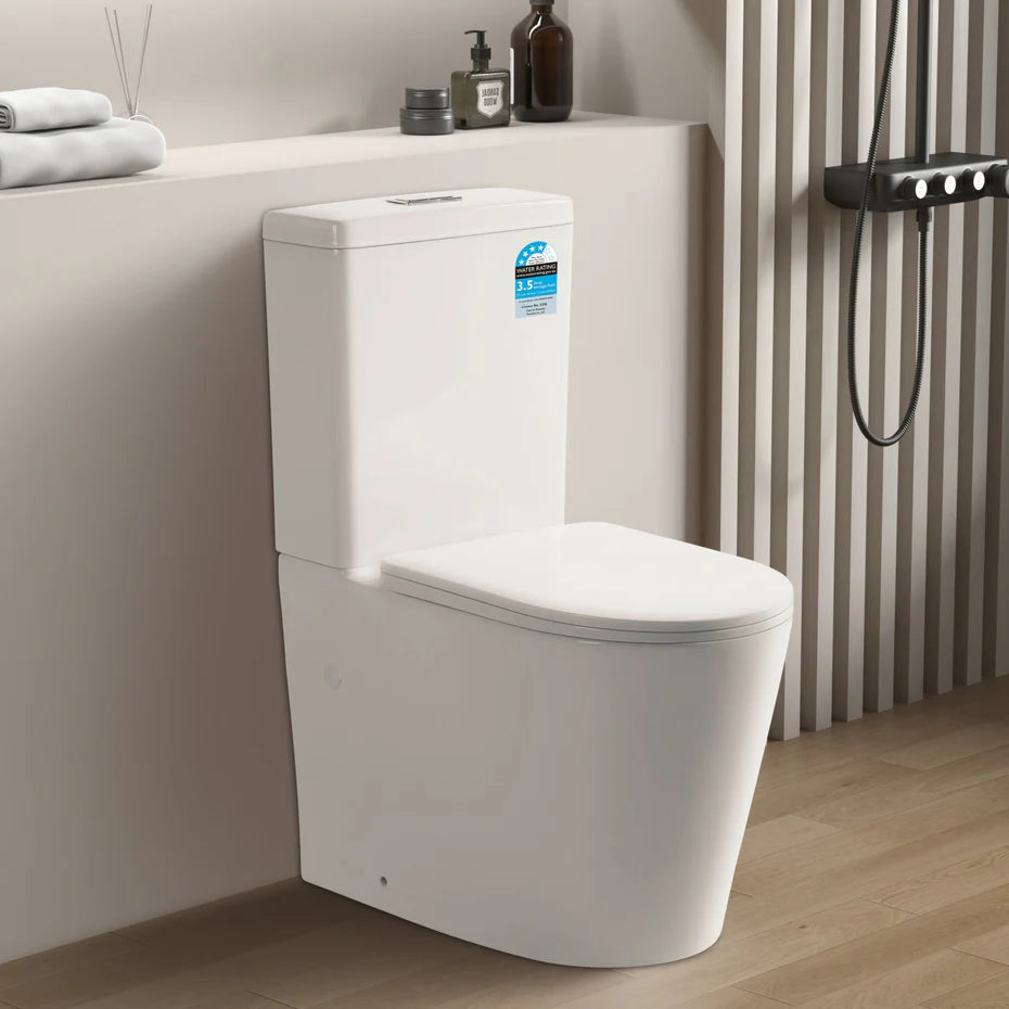 White toilet in a bathroom setting with towels and toiletries on a shelf.