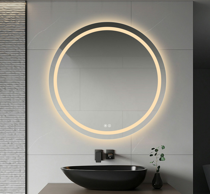 A round frameless LED mirror with anti-fog feature, illuminated with warm white light, mounted above a bathroom sink.
