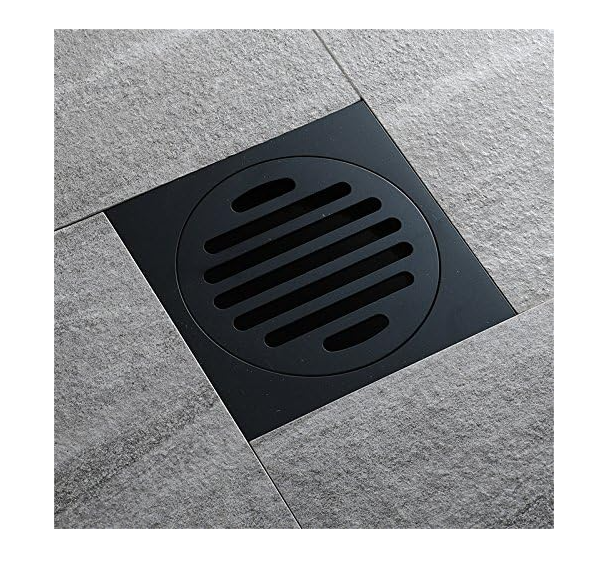 Black square floor drain cover on a gray tiled floor
