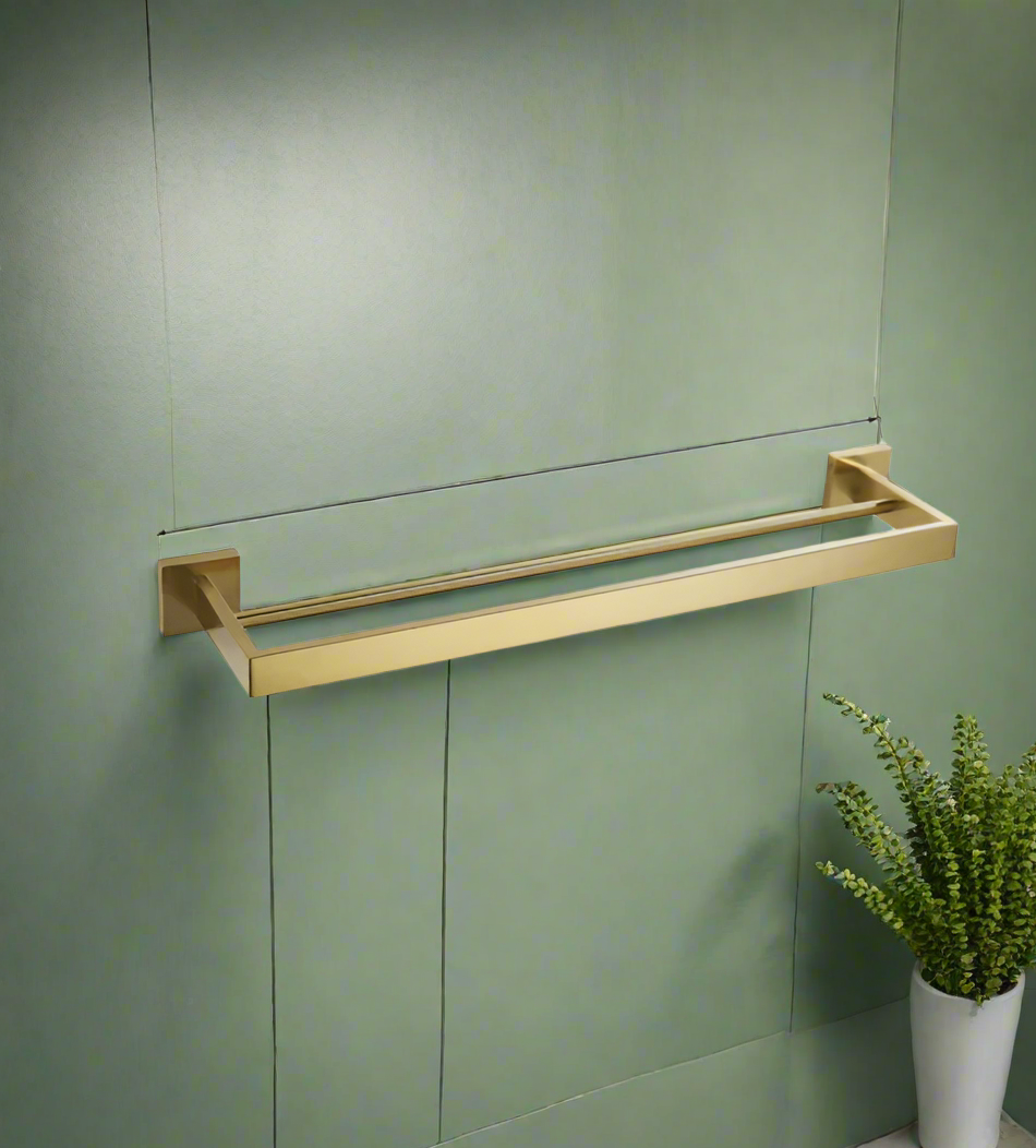 A black square double towel rail rack mounted on a white wall with a gray towel hanging on it, and a plant to the left.