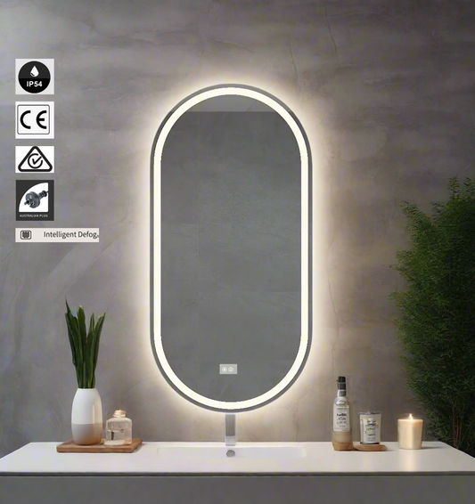 Bathroom vanity with a illuminated mirror, plants, and candles on a neutral background