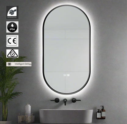 Bathroom with a large oval mirror with lights, sink, and toiletries .