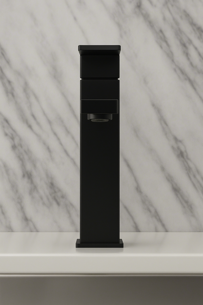Black freestanding bathtub filler against a marble wall