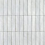 White marble tiles with subtle gray veining on a grid pattern