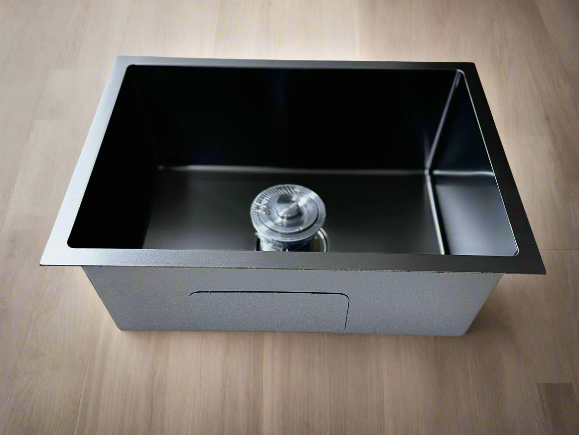 A stainless steel kitchen sink designed for under/Top/Flush Mount installation, displayed against a wooden background.