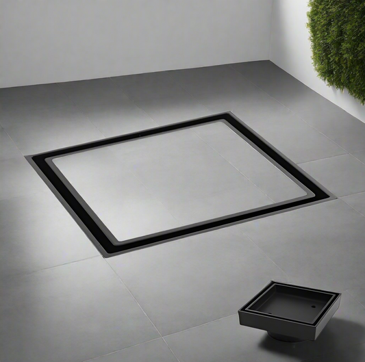 A black tile insert floor waste shower grate drain set against a tiled floor with a contemporary design.