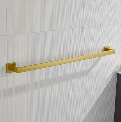 Gold towel bar mounted on a tiled bathroom wall