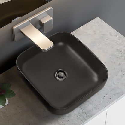 Black sink with a silver faucet on a gray countertop
