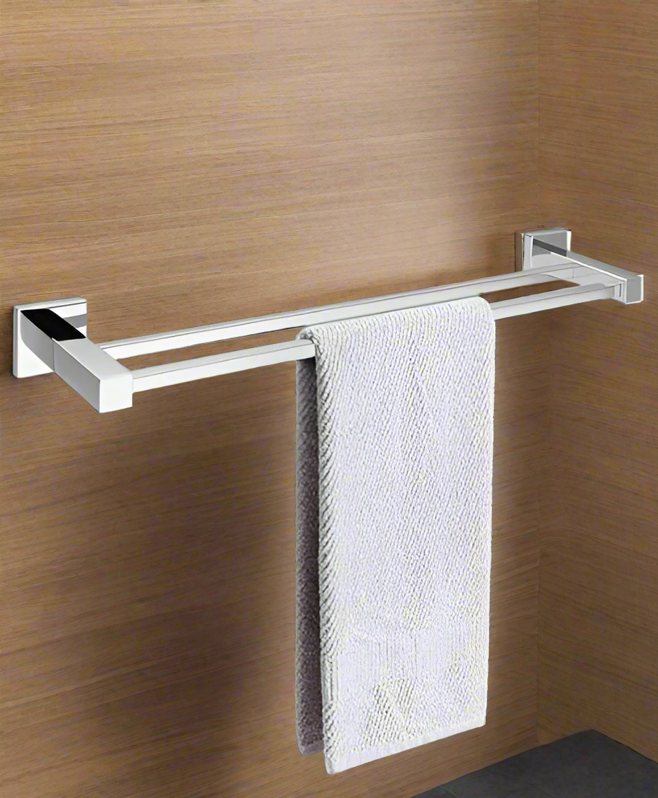 A black square double towel rail rack mounted on a white wall with a gray towel hanging on it, and a plant to the left.