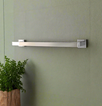 A matte black single towel rack with a square base, mounted on a wall with a towel hanging on it.